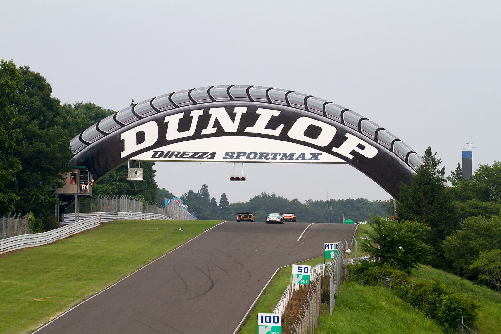 The Dunlop bridge over the track at Sportsland SUGO with GT cars coming up the hill